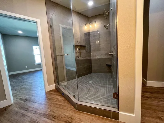 a bathroom with a glass shower door