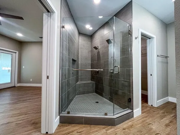 a bathroom with a glass shower door