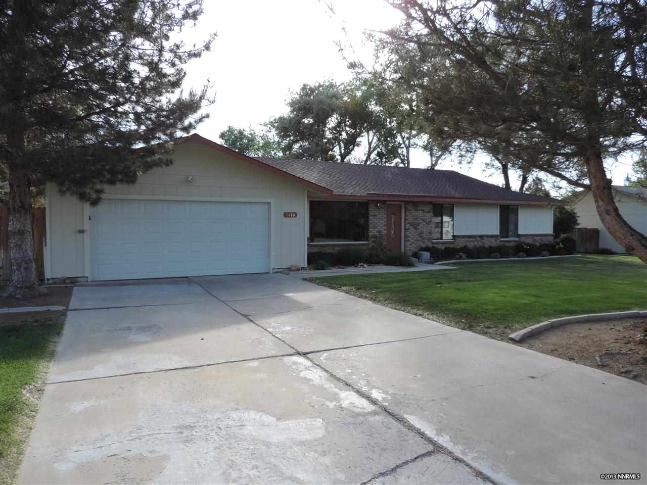 1110 Tapadero Trail Reno, NV 89521 - Photo 1 of 1 a front view of house with yard garage and green space