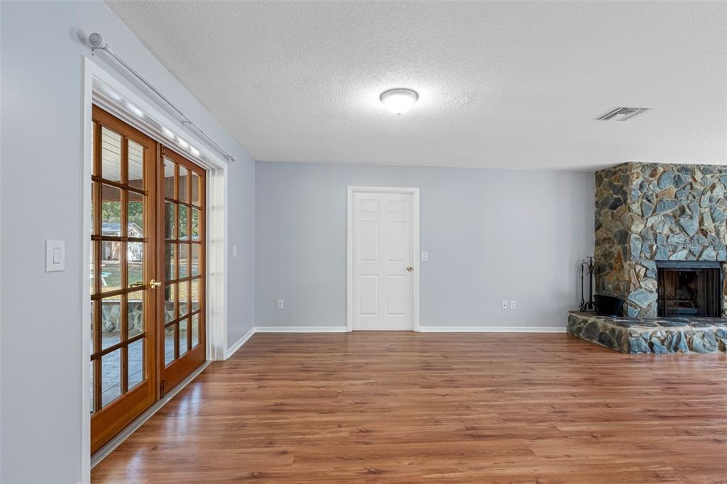 33237 Chancey Road Wesley Chapel, FL 33543 - Photo 11 of 59 a view of empty room with wooden floor and fan