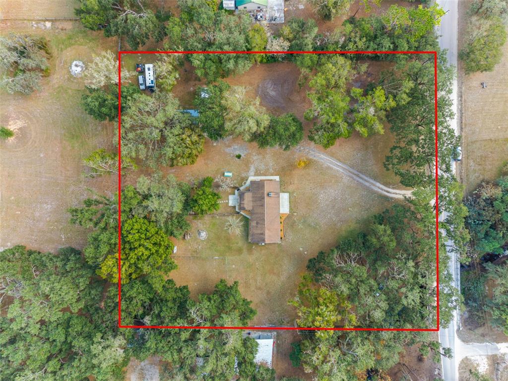 33237 Chancey Road Wesley Chapel, FL 33543 - Photo 3 of 59 an aerial view of a house with a yard and lake view