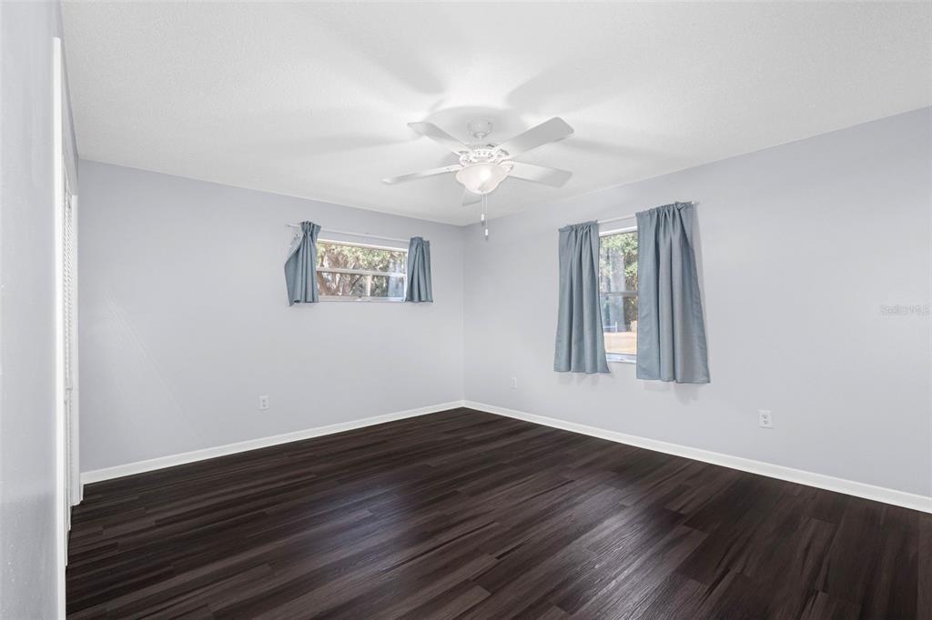 33237 Chancey Road Wesley Chapel, FL 33543 - Photo 35 of 59 a view of an empty room with wooden floor and a window
