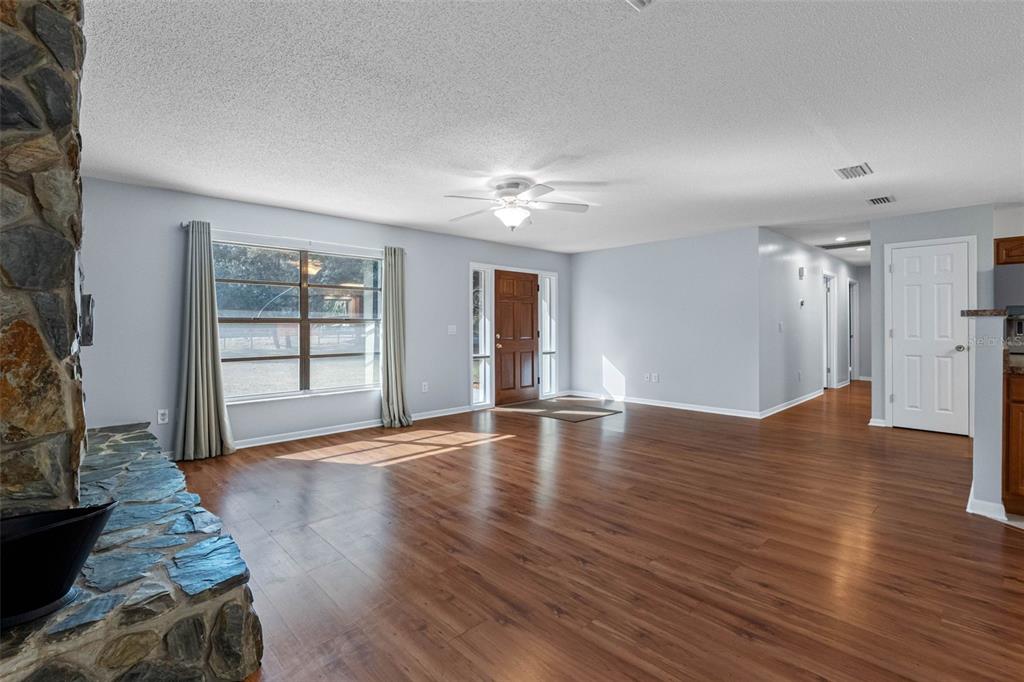 33237 Chancey Road Wesley Chapel, FL 33543 - Photo 6 of 59 a view of an empty room with window and wooden floor