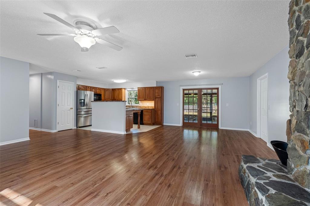 33237 Chancey Road Wesley Chapel, FL 33543 - Photo 7 of 59 a view of an empty room with wooden floor and a window
