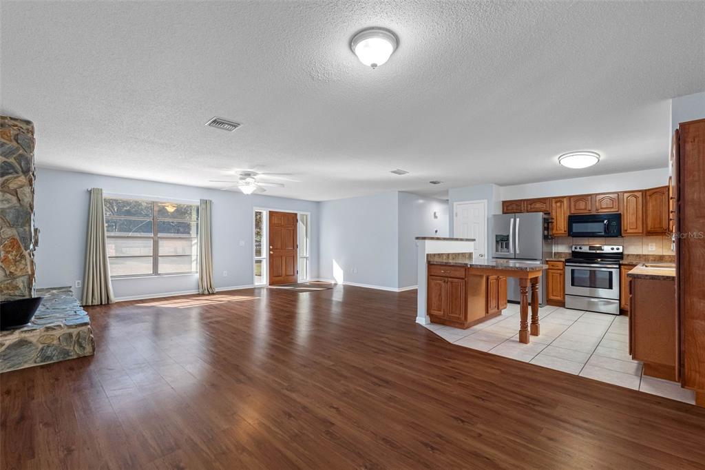 33237 Chancey Road Wesley Chapel, FL 33543 - Photo 10 of 59 a view of kitchen with furniture and wooden floor