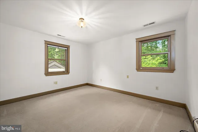 an empty room with windows and closet