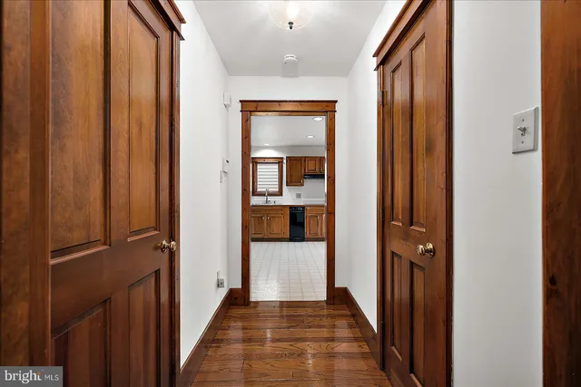 a view of a hallway with wooden shelves
