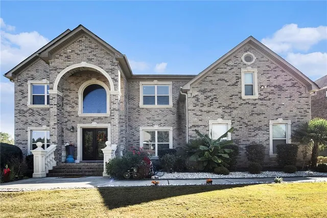 a front view of a house with a yard