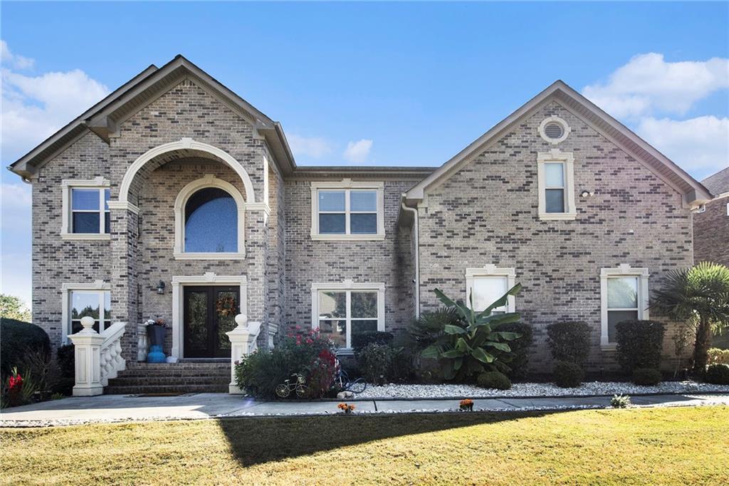 a front view of a house with a yard