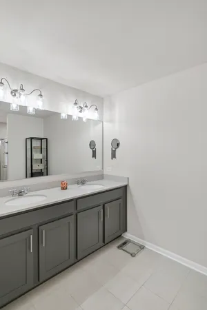 a spacious bathroom with a double vanity sink and mirror
