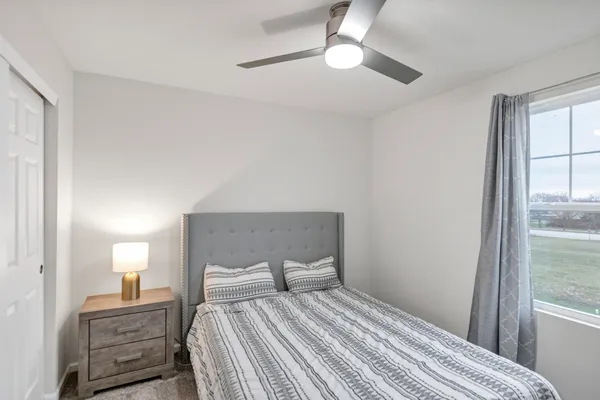 a bedroom with a bed and a window