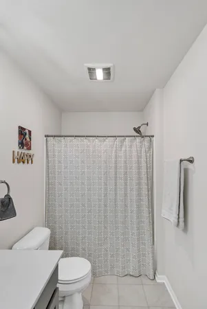 a bathroom with a toilet and a shower