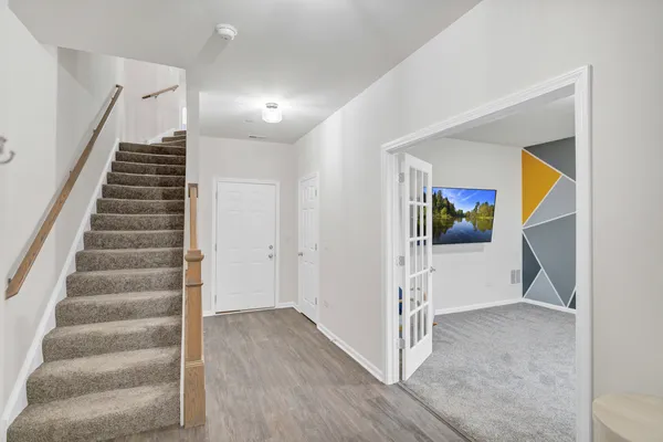 a view of an entryway with wooden floor
