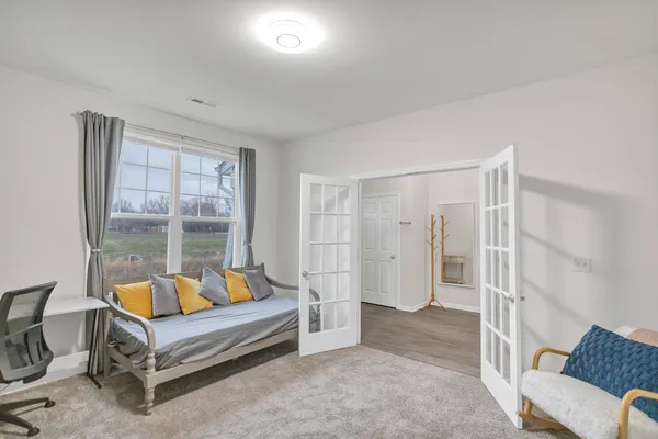 a living room with furniture and a large window