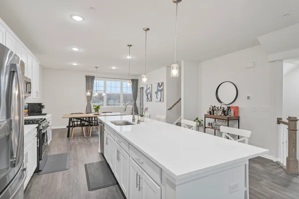 a large kitchen with sink a counter space and stainless steel appliances