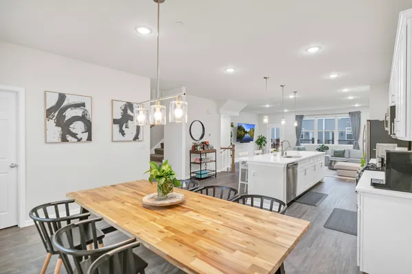 a living room with kitchen island furniture and a chandelier