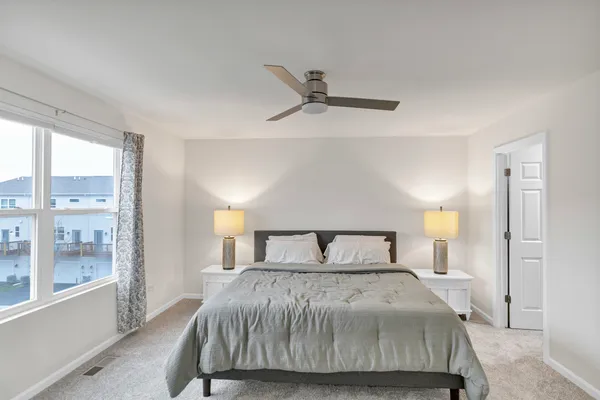 a bedroom with a large bed and a large window