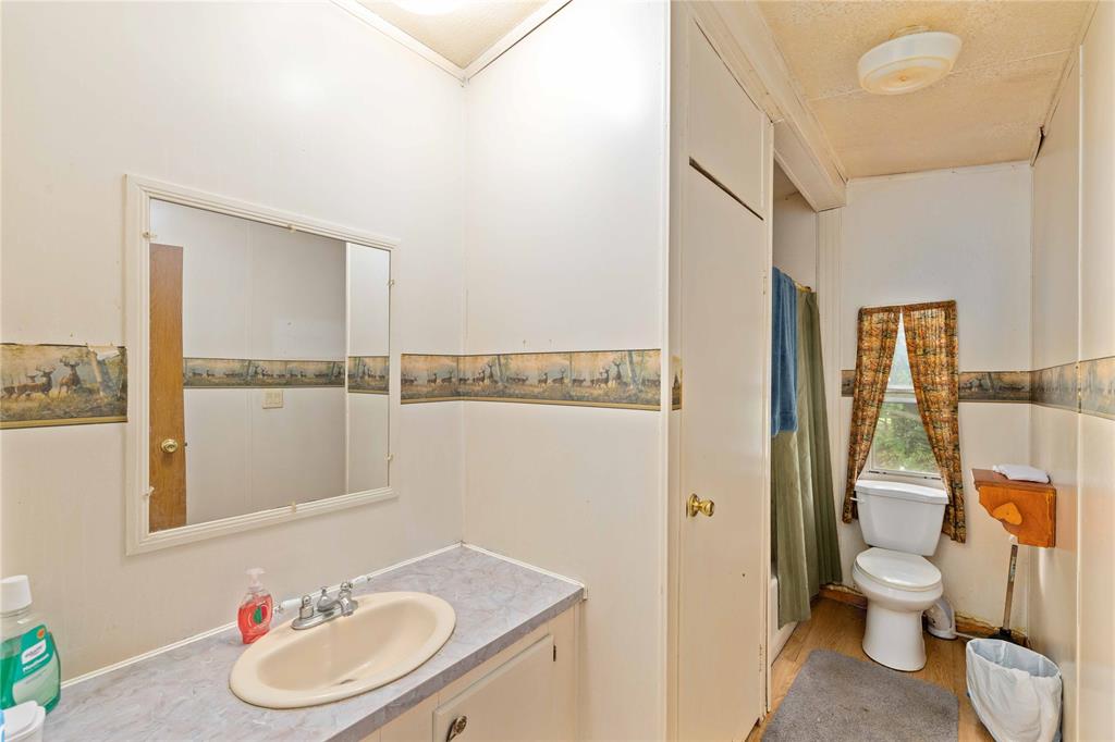 210 7th Street Blanket, TX 76432 - Photo 15 of 33 a bathroom with a sink and a mirror