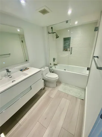 a spacious bedroom with a bed and a large mirror