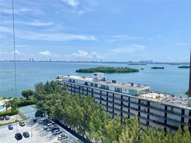 a kitchen with stainless steel appliances a sink a stove a refrigerator and cabinets