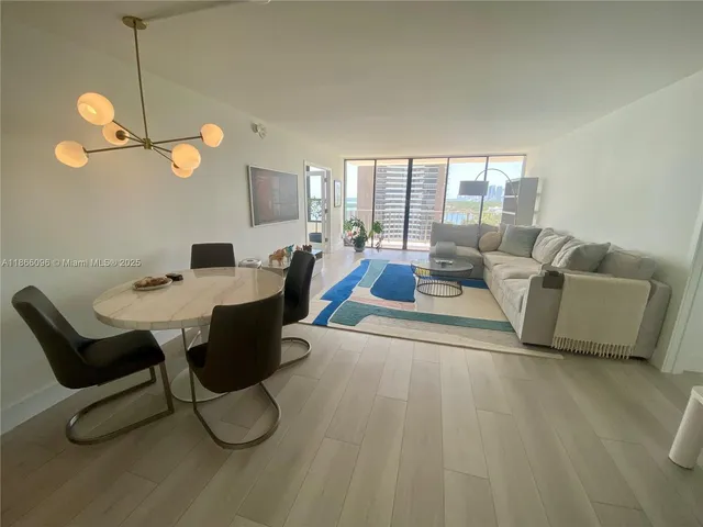 a view of a dining room with furniture and chandelier
