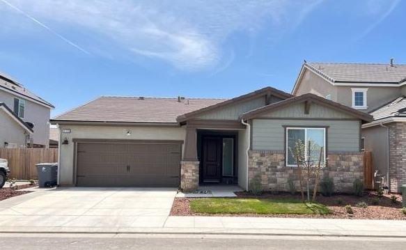 a front view of a house with garage