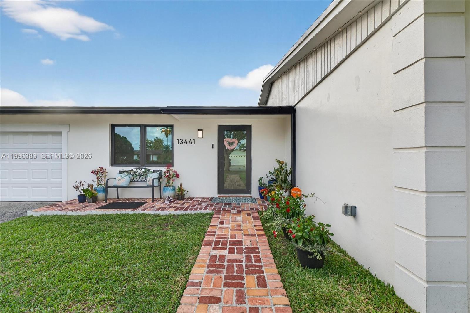 13441 Southwest 74th Street Miami, FL 33183 - Photo 2 of 51 a front view of a house with garden