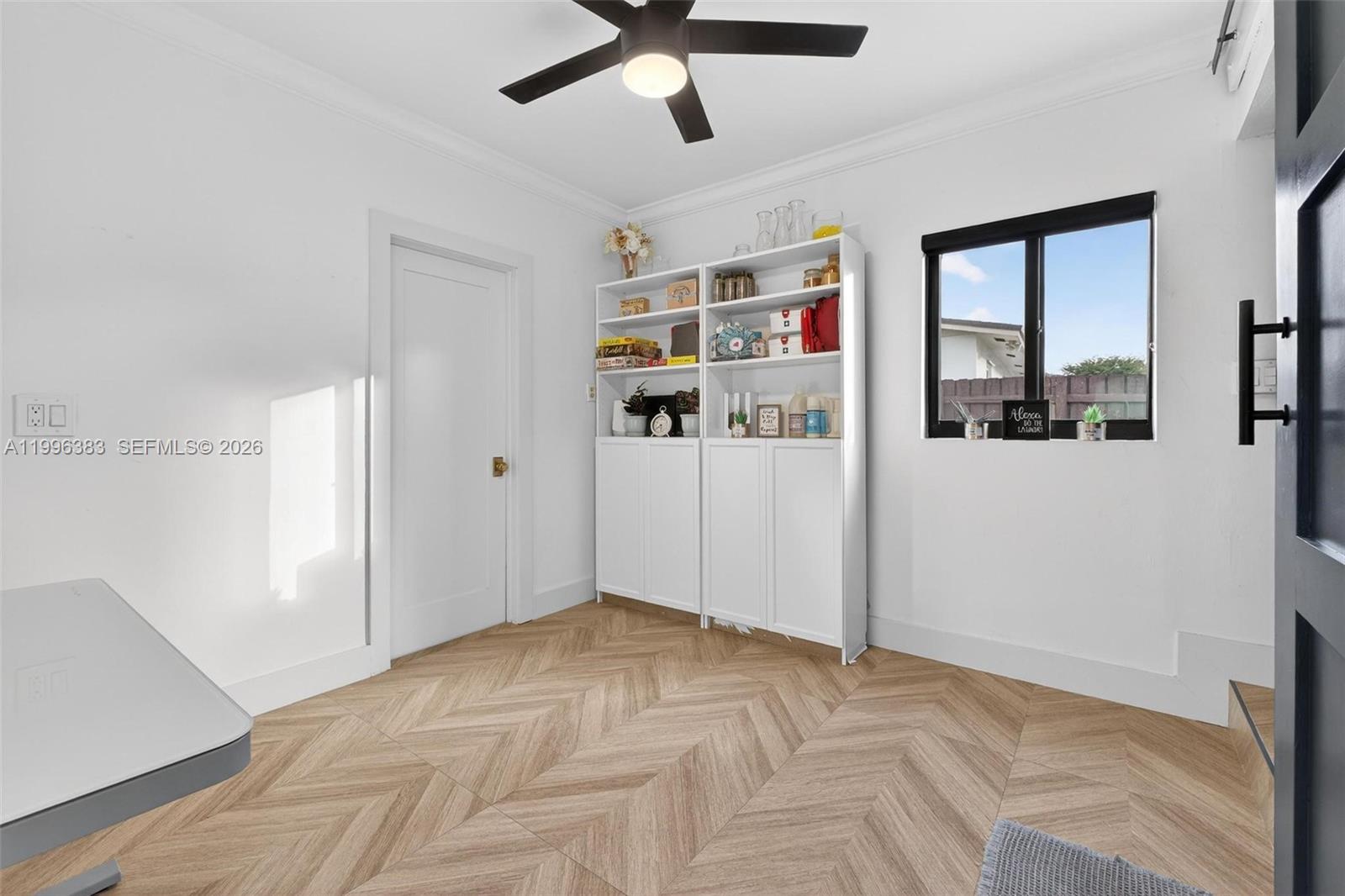 13441 Southwest 74th Street Miami, FL 33183 - Photo 24 of 51 a view of a livingroom with a ceiling fan & windows