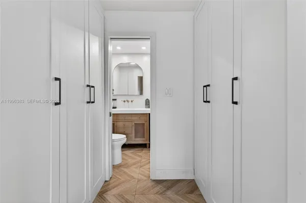 a bathroom with a sink toilet vanity and shower