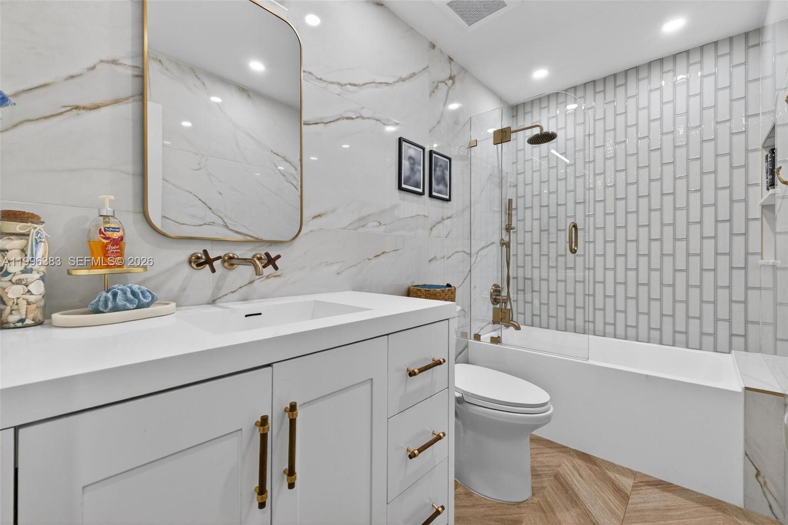 13441 Southwest 74th Street Miami, FL 33183 - Photo 28 of 51 a bathroom with a sink toilet vanity and shower