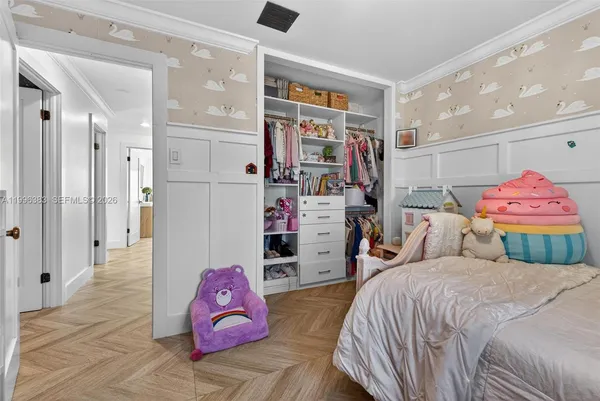 a bedroom with a bed and a chandelier