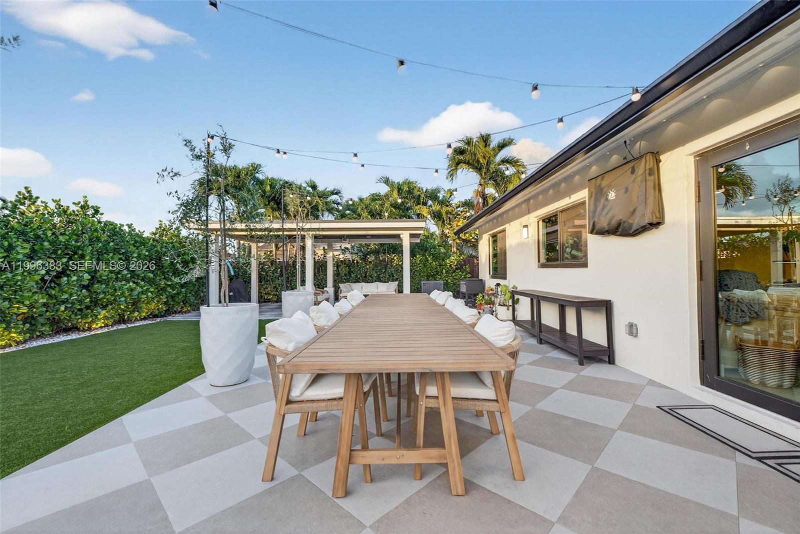 13441 Southwest 74th Street Miami, FL 33183 - Photo 33 of 51 a patio with table and chairs