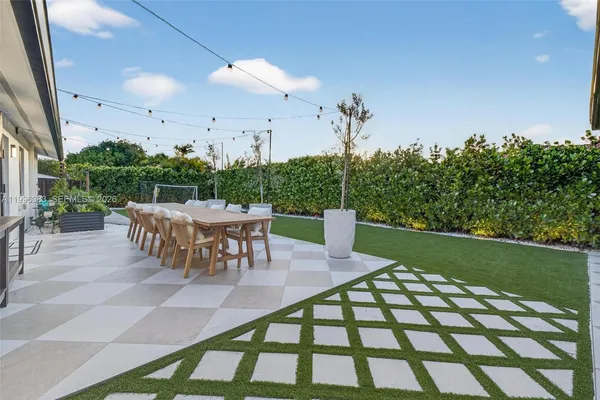 a living room with patio furniture and garden