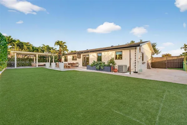 a view of a house with a backyard