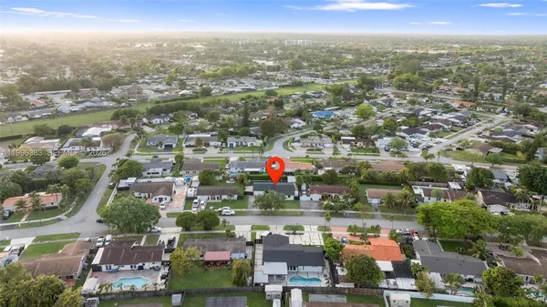 an aerial view of residential houses with outdoor space