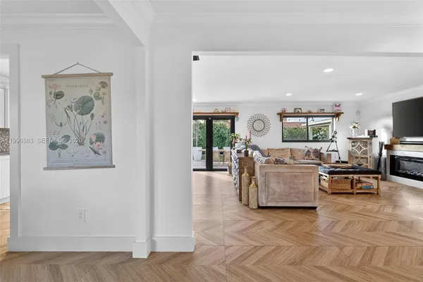 a living room with furniture and view of kitchen