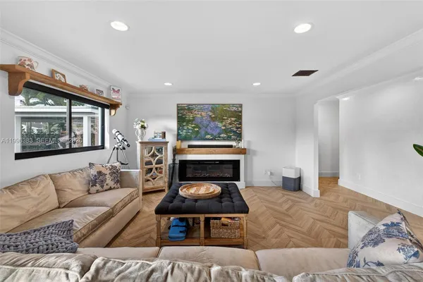 a living room with furniture a couch and large window