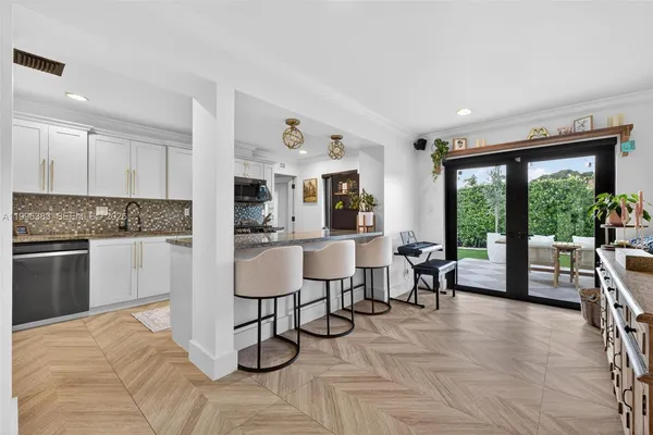 a living room with furniture large window and chairs