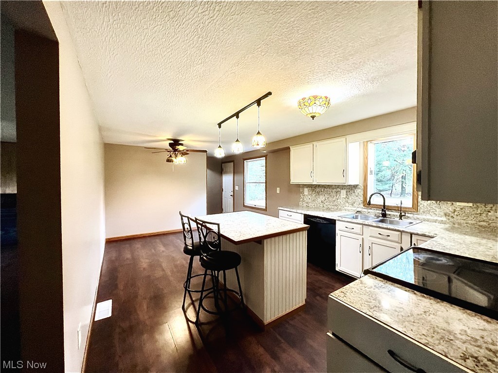 3122 Bedrock Road Northwest Dellroy, OH 44620 - Photo 15 of 23 Kitchen with sink, a kitchen island, ceiling fan, white cabinets, and pendant lighting