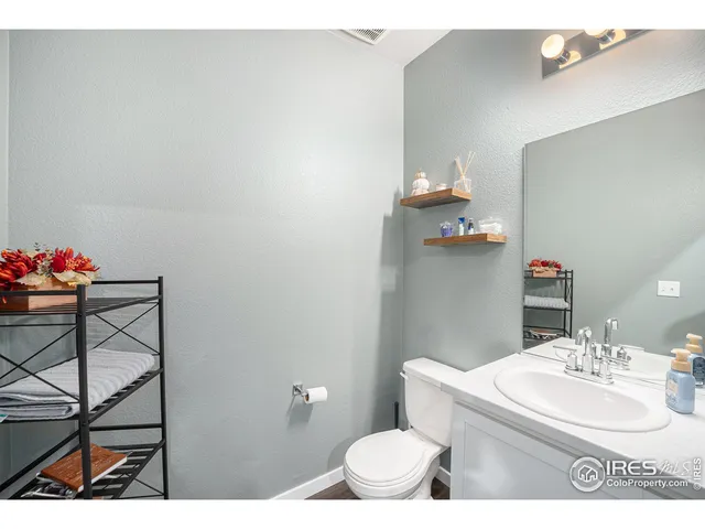 a bathroom with a sink mirror and toilet