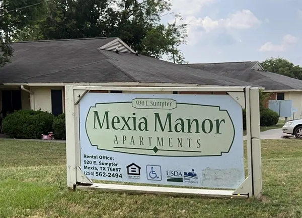 a view of outdoor space with a garden and signage