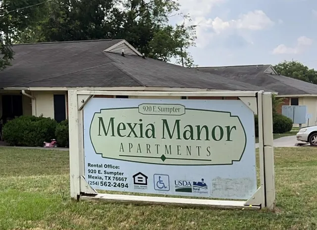 a view of outdoor space with a garden and signage