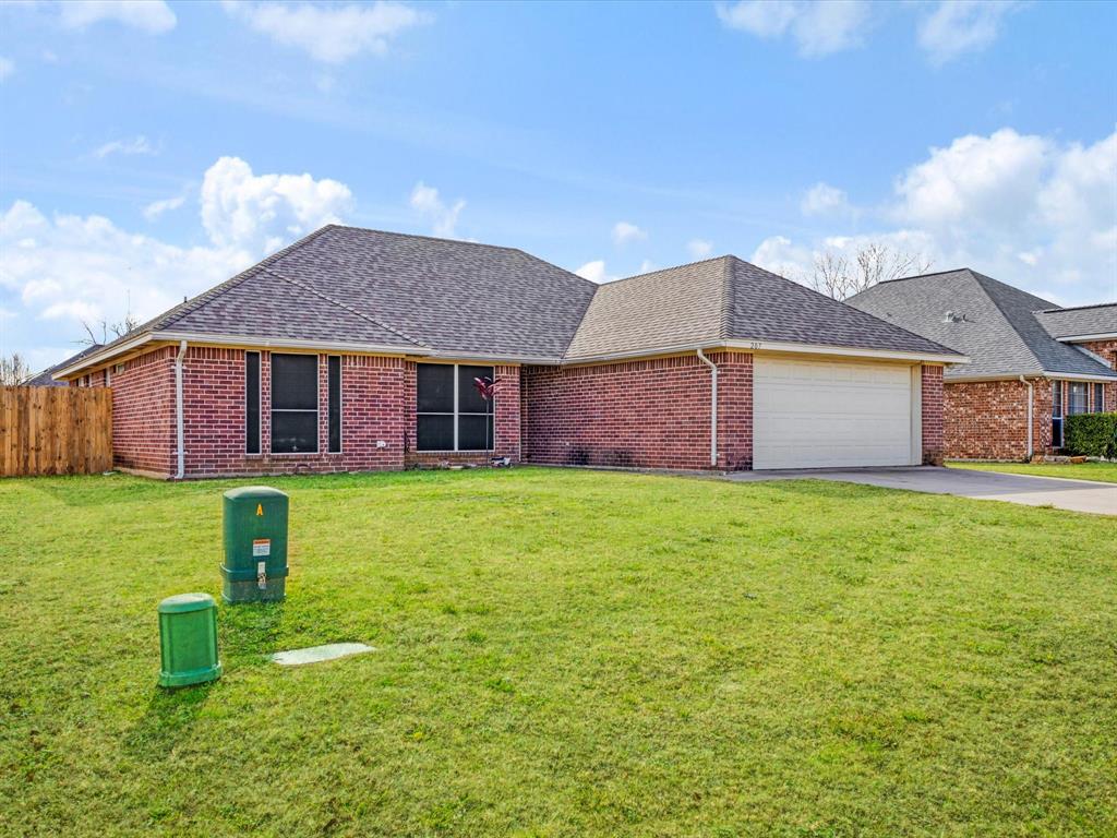207 Quail Run Aubrey, TX 76227 - Photo 4 of 30 View of front of property featuring roof with shingles, brick siding, and driveway