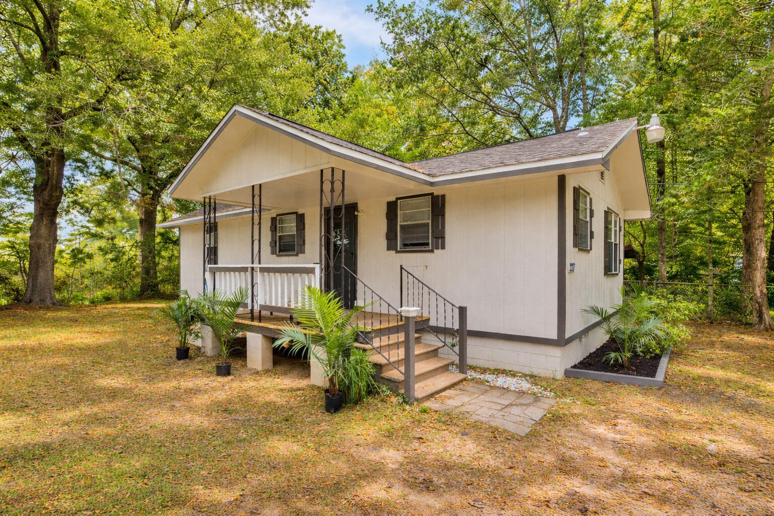 227 East 3rd Avenue Crestview, FL 32536 - Photo 1 of 26 a front view of house with yard and trees in the background