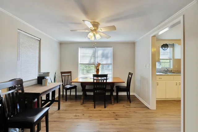 a view of a dining room with furniture window and wooden floor