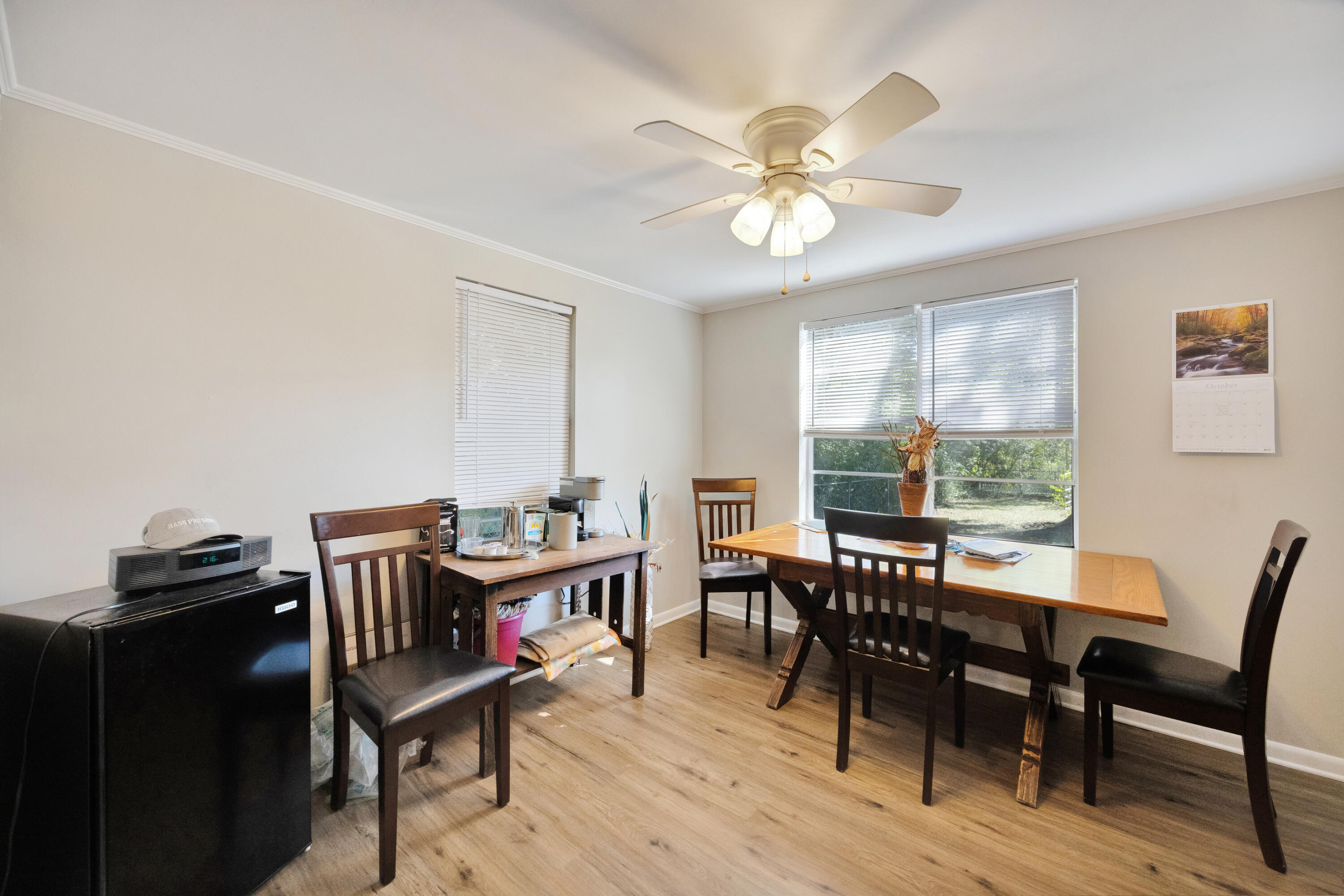 227 East 3rd Avenue Crestview, FL 32536 - Photo 13 of 26 a view of a dining room with furniture window and wooden floor