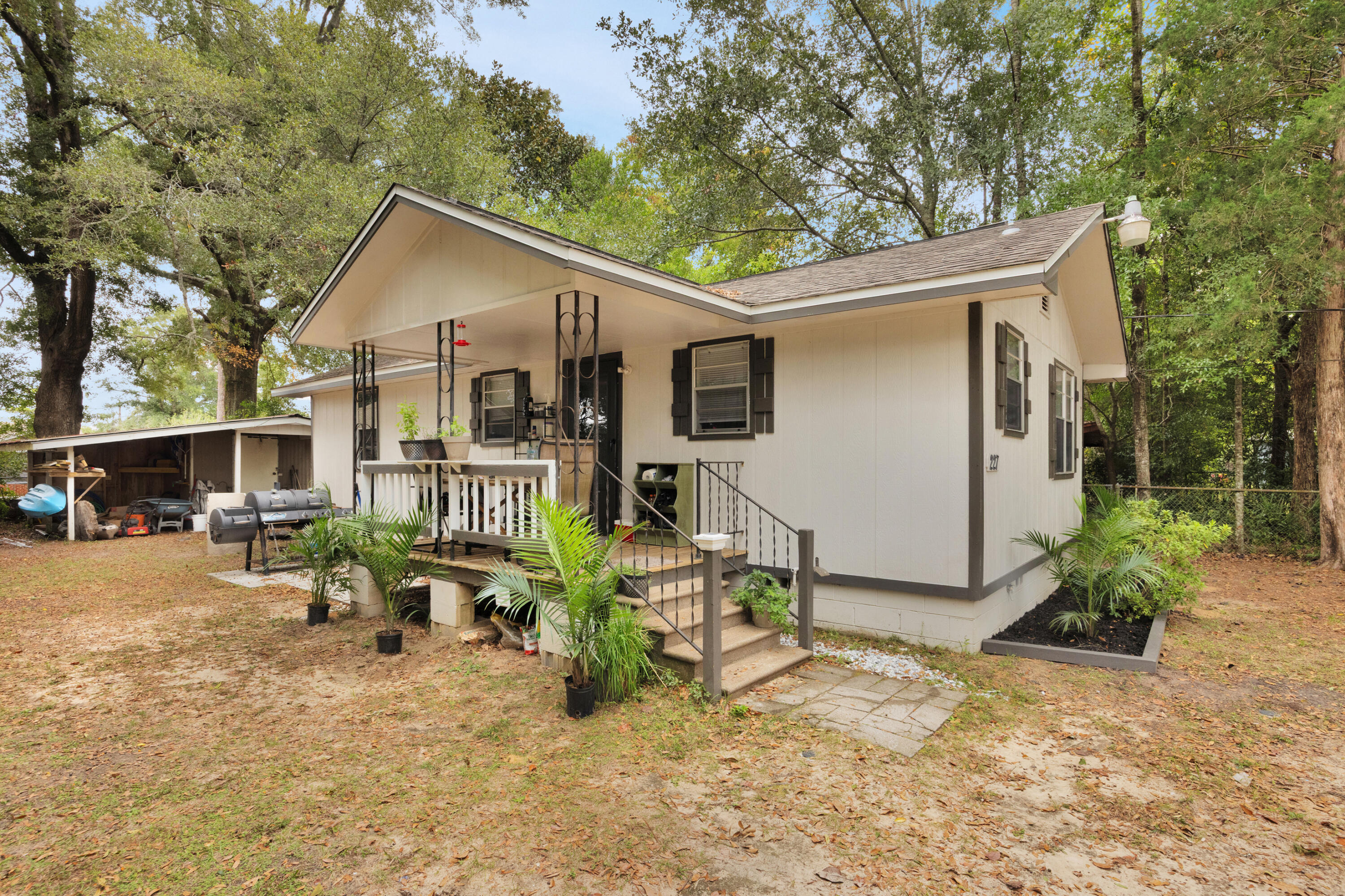227 East 3rd Avenue Crestview, FL 32536 - Photo 2 of 26 a view of a house with a yard covered in snow