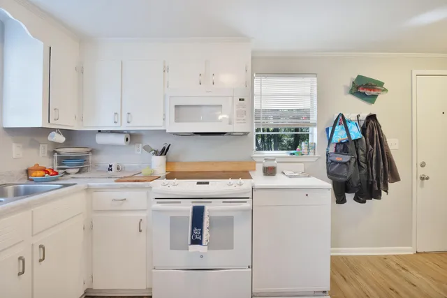 a kitchen with a white cabinets and white appliances