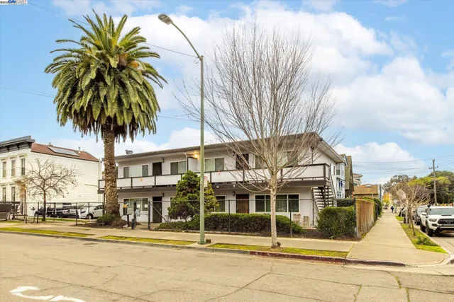 a view of a house with palm trees
