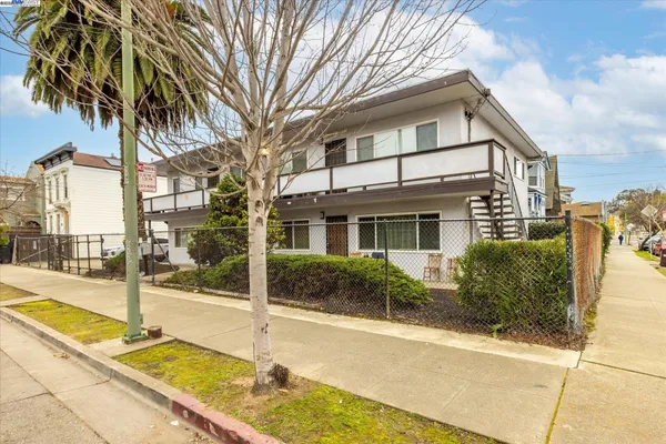 a view of a patio with table and chairs potted plants and a palm tree